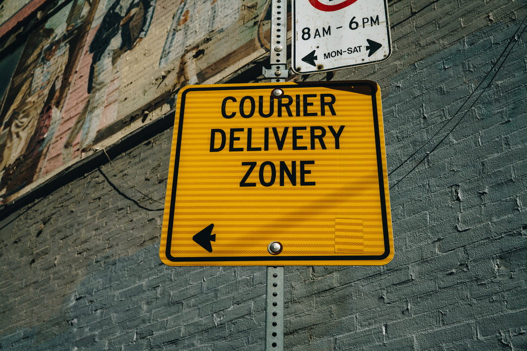 Courier delivery zone sign indicating designated area for package drop-off and pickup