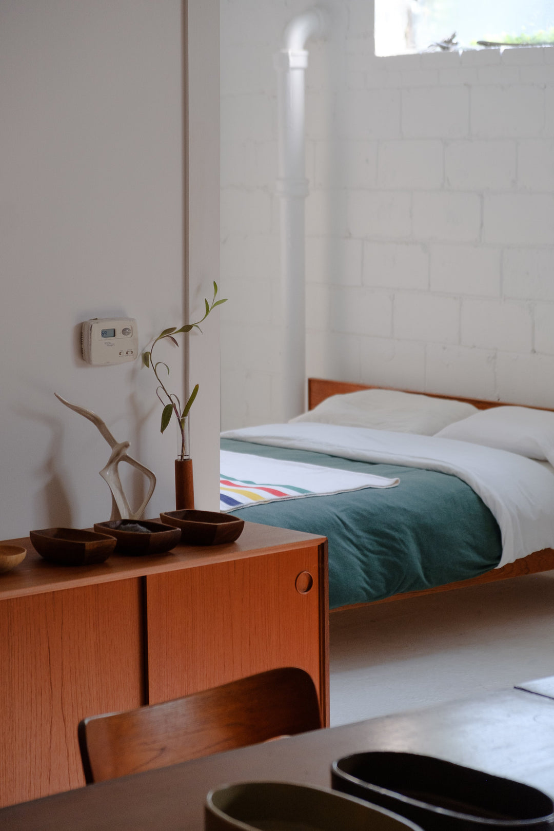 Mid century style furniture in white warehouse style room