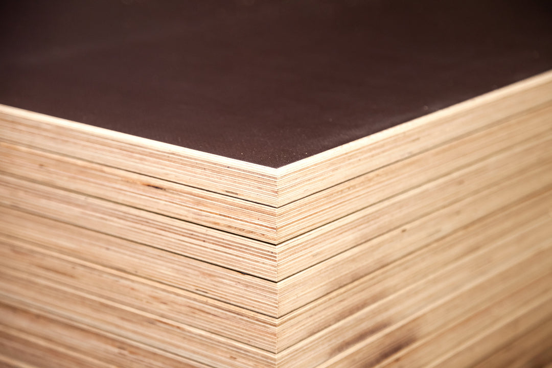 Stack of wooden panels with a dark brown top surface