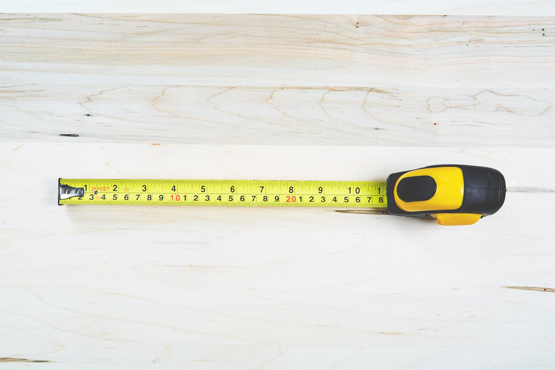 Tape measure pulled out to 28cm on wood