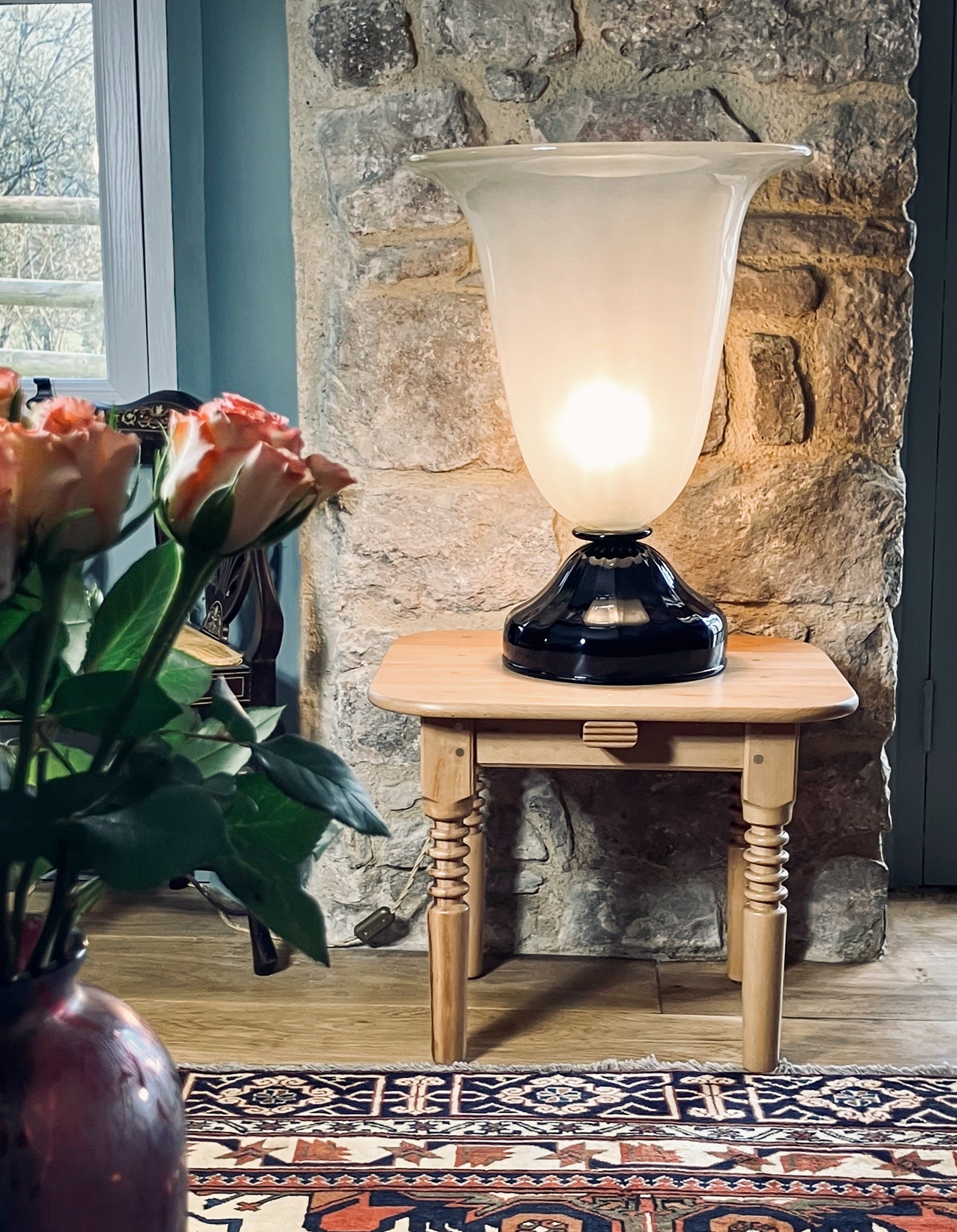 Cityfarm seat set up as side table with art deco lamp and roses in the foreground