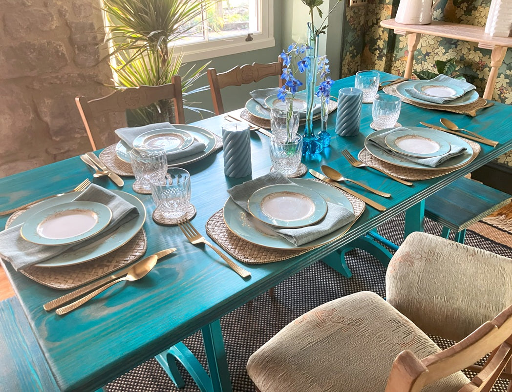 colpop dining table set up with 6 places in turquoise with chairs and countrystyle decor