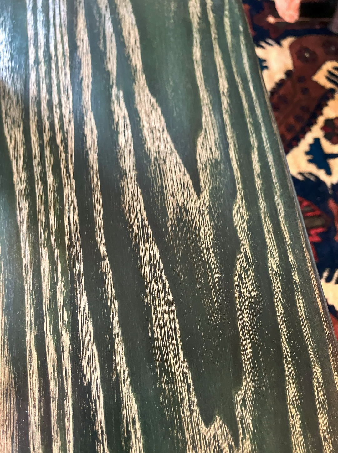 Close-up of hand-dyed ash wood with gold-filled grain detail.